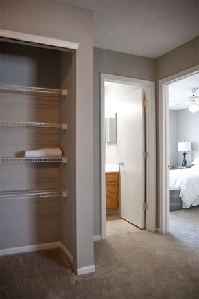 Canal Winchester apartment for rent - A bedroom with a white bed and a walk-in closet.