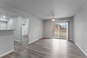Bentonville apartment for rent - A spacious room with a sliding glass door leading to a balcony.
