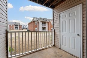 Bentonville apartment for rent - A view from a balcony looking out at apartment buildings.