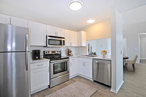 Southfield apartment for rent - A kitchen with white cabinets and stainless steel appliances.