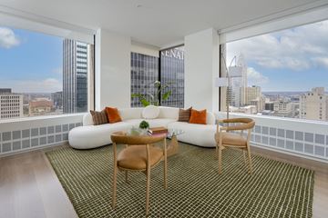 Columbus apartment for rent - A living room with a white couch and a green rug.
