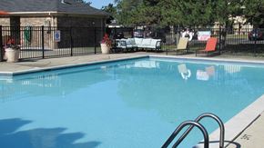 Livonia apartment for rent - A pool with a diving board and a sign that says "SAFETY FIRST".
