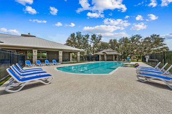 Swimming pool with tanning shelf and lounge seating