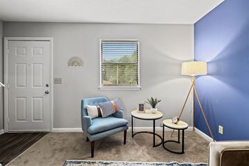 Fayetteville apartment for rent - a living room with a chair and a table and a window