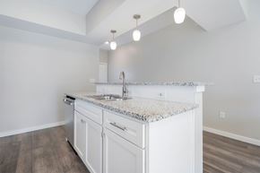 Grove City apartment for rent - A kitchen with a granite countertop and white cabinets.