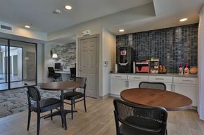 New Braunfels apartment for rent - A kitchen with a table and chairs in front of a wall with a stone pattern.