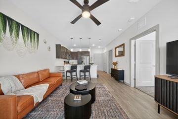 San Antonio apartment for rent - A living room with a brown leather couch and a black coffee table.