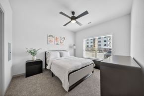 San Antonio apartment for rent - A bedroom with a bed, nightstand, and a ceiling fan.