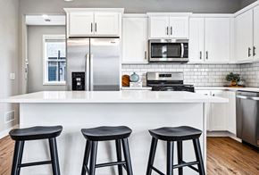 Maple Grove apartment for rent - a kitchen with a counter top and three stools