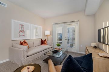 Columbus apartment for rent - A living room with a grey couch, a coffee table, and a painting on the wall.