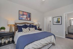 Columbus apartment for rent - A bedroom with a large bed and a painting on the wall.