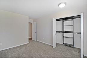 Kalamazoo apartment for rent - a bedroom with white walls and a closet with a mirrored door