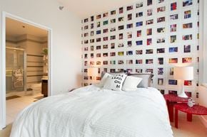Chicago apartment for rent - a bedroom with a bed and a wall of photos