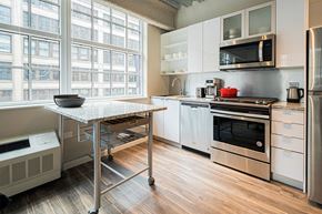 Chicago apartment for rent - a kitchen with stainless steel appliances and a table