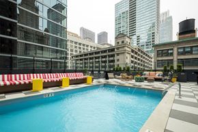 Chicago apartment for rent - a swimming pool on the rooftop of a building with skyscrapers