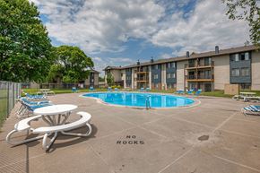 Urbandale apartment for rent - our apartments have a resort style pool with chairs and tables