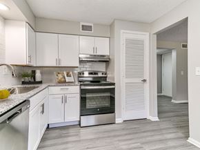 West Des Moines apartment for rent - A kitchen with white cabinets and a stainless steel oven.