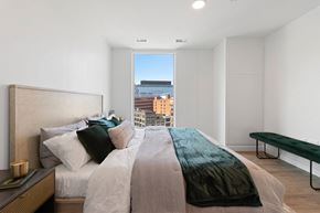 Detroit apartment for rent - a bedroom with a bed and a large window