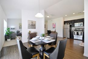 East Lansing apartment for rent - A modern dining room with a black table and chairs.