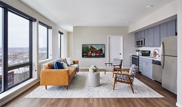 Saint Paul apartment for rent - A living room with a yellow couch and a painting on the wall.