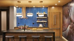 Saint Paul apartment for rent - A kitchen with a bar area and a blue tile backsplash.