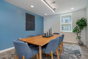 Charlestown apartment for rent - A dining room with a wooden table and blue chairs.