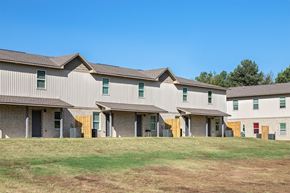 Conway apartment for rent - A row of houses with a grassy field in front.