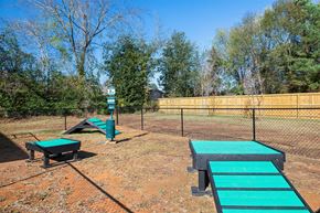 Conway apartment for rent - A playground with a green slide and a wooden fence.