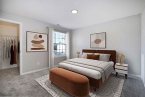 Howell apartment for rent - A bedroom with a large bed and two framed artworks on the wall.