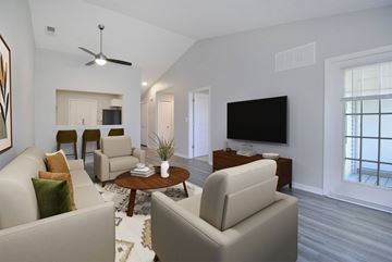 Howell apartment for rent - A living room with a white couch and a television.