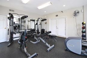 Howell apartment for rent - A gym with a variety of equipment including treadmills, weights, and a rowing machine.