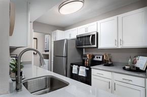 Highland Heights apartment for rent - A modern kitchen with a stainless steel sink and white cabinets.