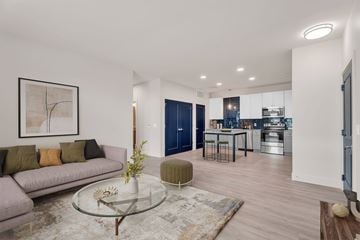 Perrysburg apartment for rent - A modern living room with a glass coffee table and a grey sofa.