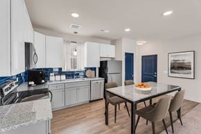 Perrysburg apartment for rent - A modern kitchen with a dining table and chairs.
