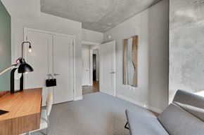 Minneapolis apartment for rent - A modern living room with a grey sofa and a wooden table.