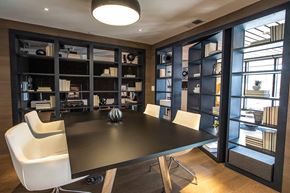 Minneapolis apartment for rent - A modern dining room with a black table and white chairs.