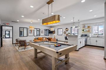 East Lansing apartment for rent - a pool table in a living room with a kitchen