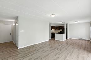 Hobart apartment for rent - A spacious room with wooden flooring and white walls.