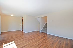 Kalamazoo apartment for rent - a living room with a hard wood floor and a staircase