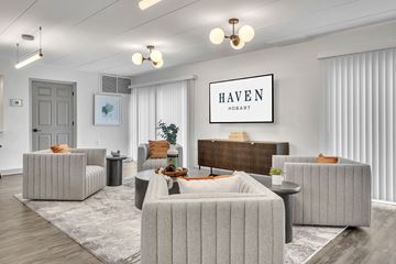Hobart apartment for rent - a living room with couches and chairs and a tv