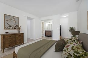 Racine apartment for rent - a bedroom with a bed and a dresser and a bathroom