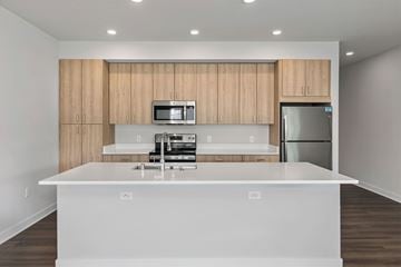 Sun Prairie apartment for rent - A modern kitchen with wooden cabinets and stainless steel appliances.