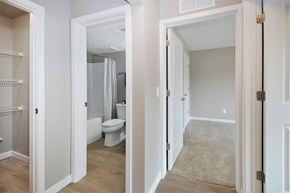 Ann Arbor apartment for rent - a bedroom with a toilet and a hallway to a bathroom