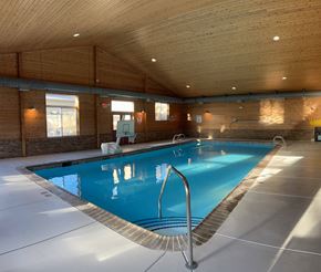 Portage apartment for rent - A large indoor swimming pool with a diving board.