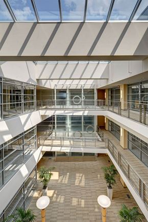 Lansing apartment for rent - A modern atrium with a glass ceiling and a skylight.