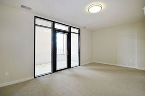 Lansing apartment for rent - A room with a sliding glass door leading to a balcony.