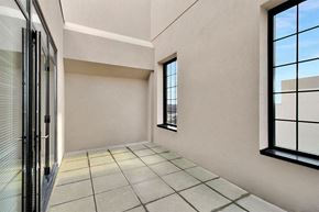 Lansing apartment for rent - A room with a tiled floor and a window with a view of the sky.