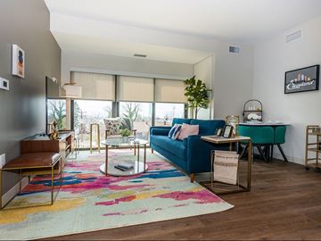 Cleveland apartment for rent - A living room with a blue couch and a colorful rug.