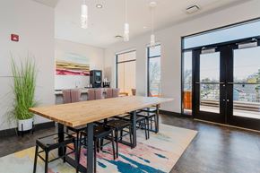 Cleveland apartment for rent - A modern dining room with a wooden table and chairs.