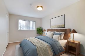 Holland apartment for rent - A bedroom with a bed, nightstand, and lamp.